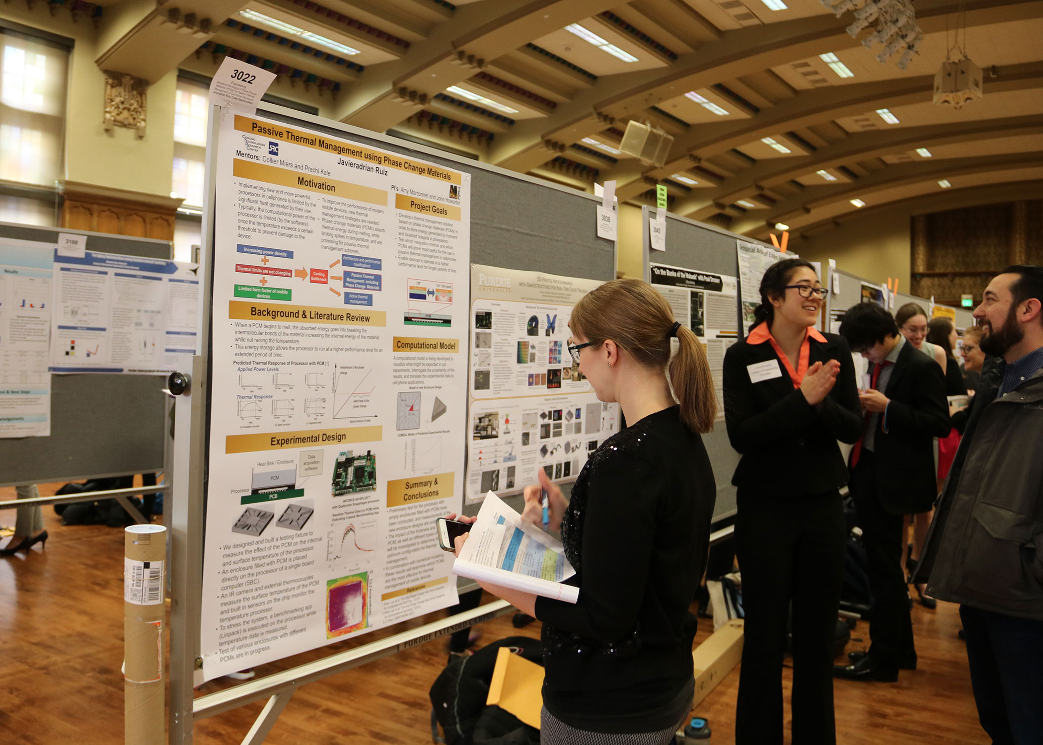 Purdue University Press Co-Interim Director Katherine Purple evaluates a Purdue student's research in the poster symposium/competition of the Office of Undergraduate Research's 2018 Research Conference (April 10).