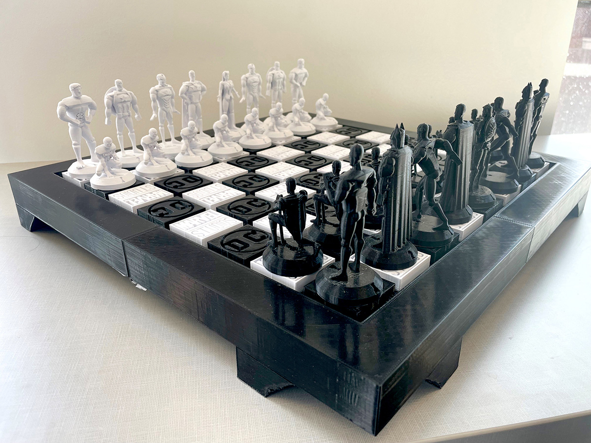 3D printed chess board unfolded set up with Marvel and DC figurine pieces.